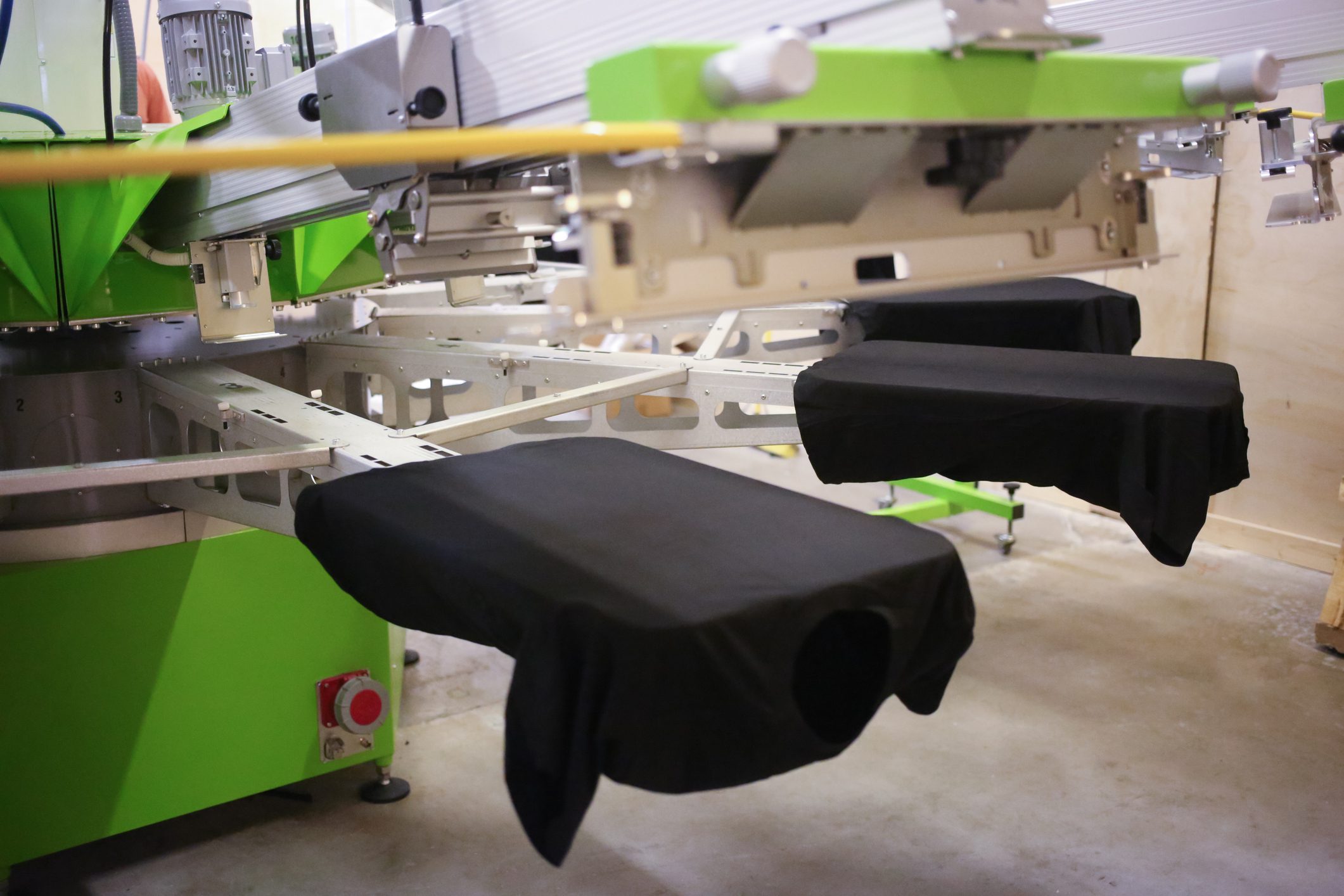 Screen printing machine with black garments.