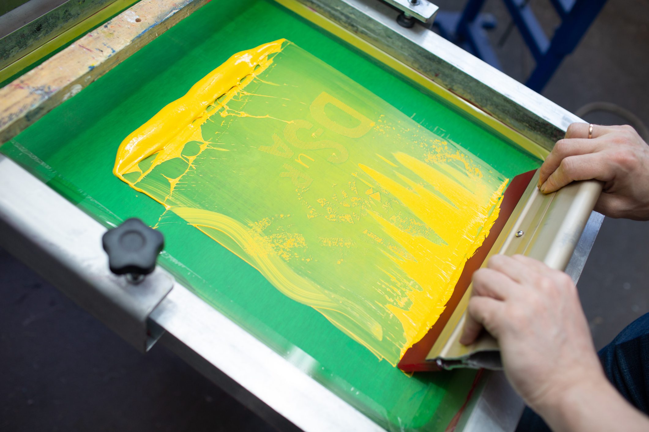 Screen printing with yellow ink on green.
