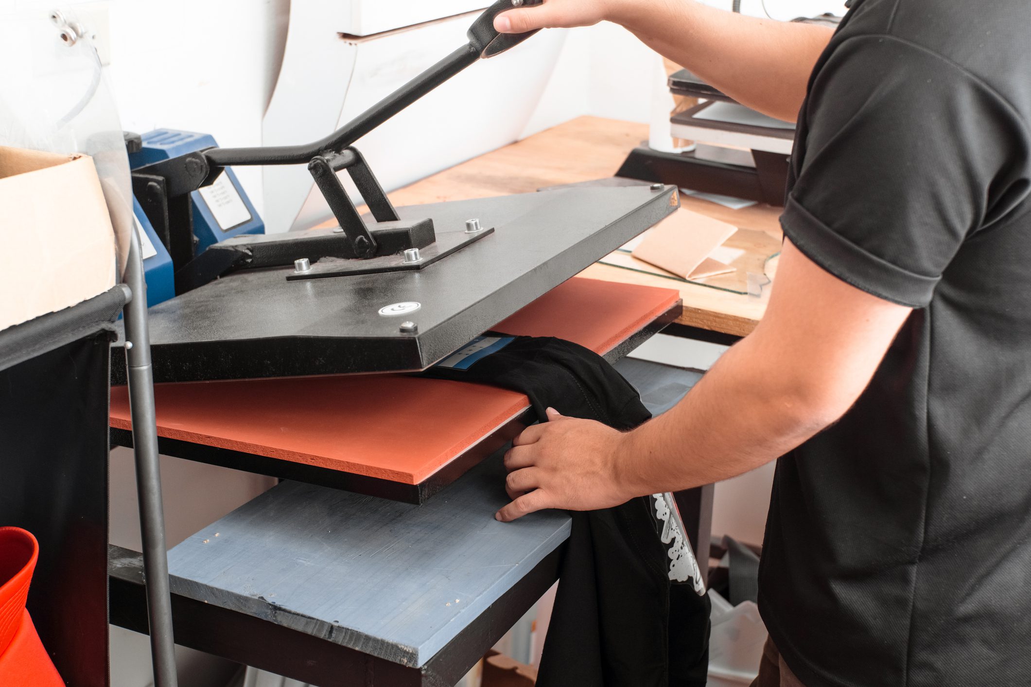 Person using a heat press machine.