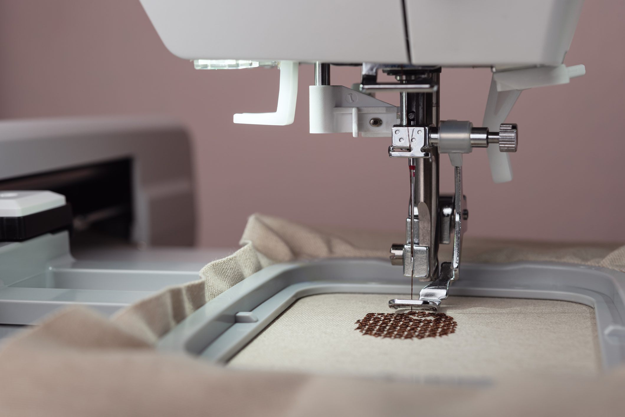 Embroidery machine stitching on fabric close-up.